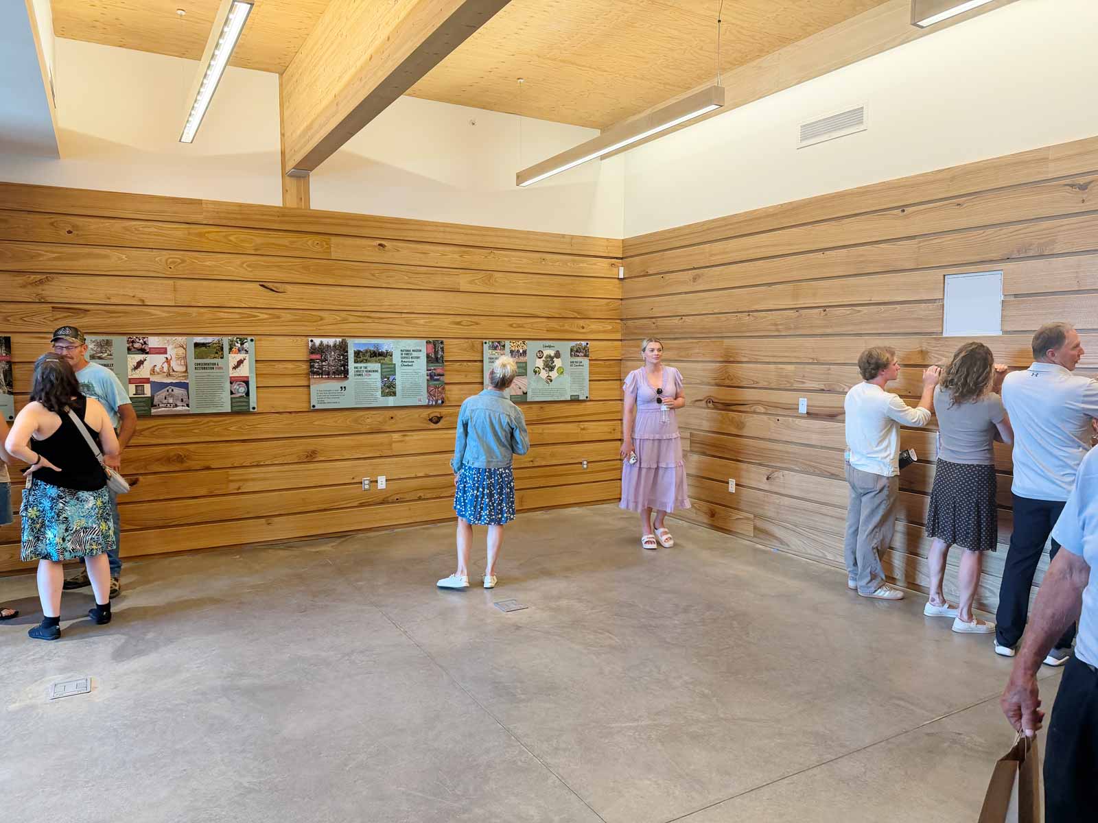 Museum visitors experience the American chestnut room at the National Museum of Forest Service History.